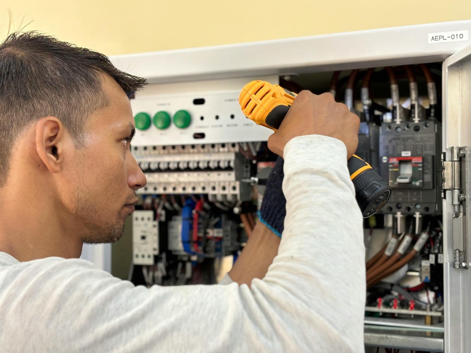 Professional electrician working on electrical panel