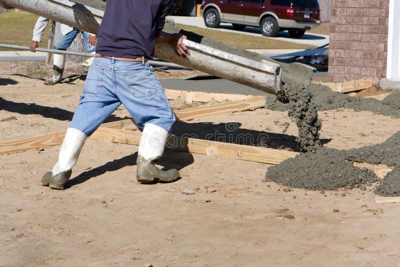 Concrete workers pouring driveway
