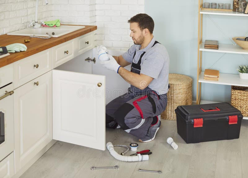 Professional plumber repairing pipes